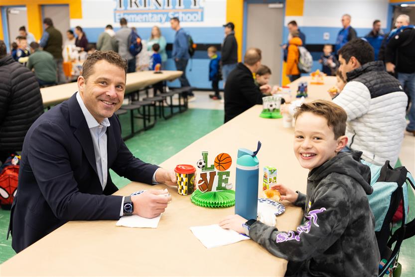 Trinity Elementary students eat donuts with dudes